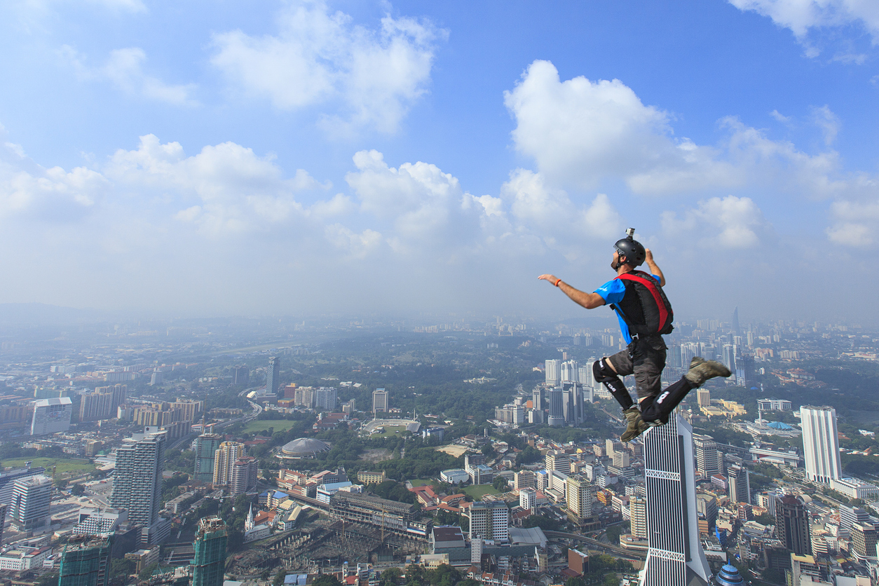 Kuala Lumpur, Malaysia-October 02, 2011: A BASE jumpers in jumps off from Kuala Lumpur Tower. KL Tower BASE Jump is an annually event and participants from experienced BASE jumpers from all around the world.
